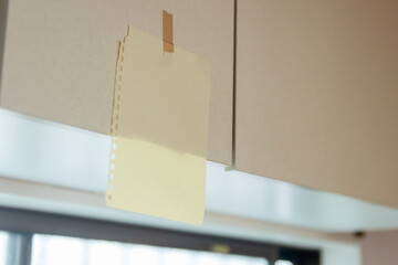 キッチンに貼ってあるメモ書き　テープで止めた一片の紙