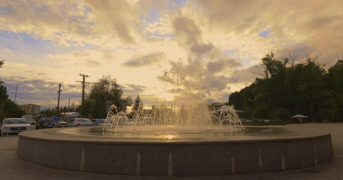 artesian fountain in the park at sunset