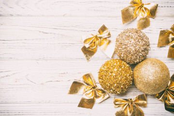 Top view of Christmas balls and creative decorations on wooden background with copy space. New Year...