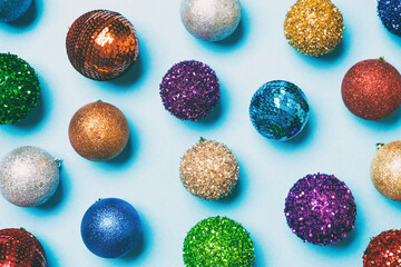 Top view of creative holiday baubles on colorful background. Christmas ornament concept