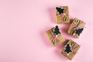 Advent christmas calendar. Wrapped gifts on pink background. Top view, flat lay - obrazy, fototapety, plakaty