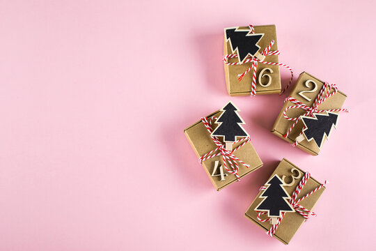 Advent Christmas Calendar. Wrapped Gifts On Pink Background. Top View, Flat Lay