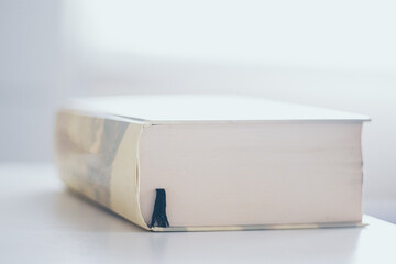 closed book on white wooden table