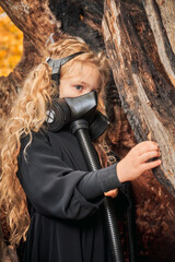 portrait of a little girl in a mask with a respirator against the background of a textured...