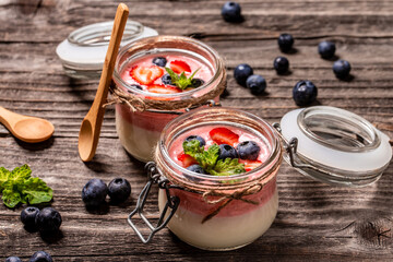Traditional Italian dessert panna cotta with fresh berries. Summer yogurt dessert. Food recipe...