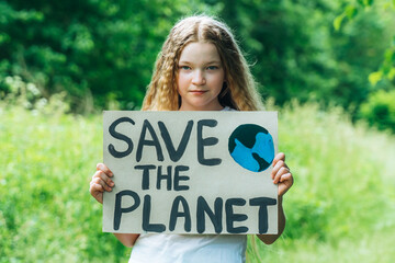 Fototapeta na wymiar caucasian blonde girl activist with save the planet poster in park. preteen kid volunteer against pollution, global warming, recycle garbage. Ecology environmental problem. Zero waste