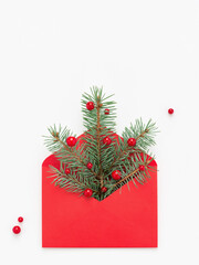 Green Christmas tree symbol in red envelope on white copy space background. Holiday concept.
