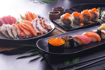 Sashimi and sushi Japanese food set. Salmon, Ikura, wasabi, fish, shrimp and tuna. - obrazy, fototapety, plakaty