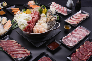 Shabu Shabu or Sukiyaki, a popular dish of pork, beef, shrimp, squid, seafood and fresh vegetables. Placed on a table with a boiling pot boiling.