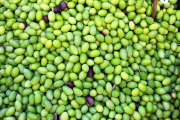 Stall with green olives at street market in Athens, Greece.