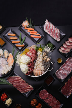 Shabu Shabu or Sukiyaki, a popular dish of pork, beef, shrimp, squid, seafood and fresh vegetables. Placed on a table with a boiling pot boiling.