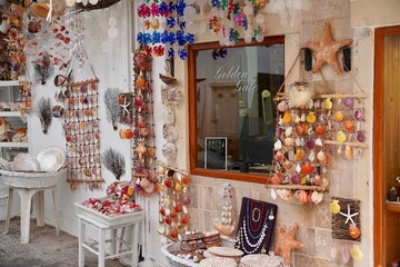 Bodrum, Turkey - August, 2020: Atmospheric local souvenir markets. Turkish Grand Bazaar. Hand-made souvenirs at street market. Souvenirs: wind music, dream catcher, evil eye keychain, beads, bracelets