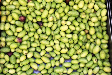 Stall with green olives at street market in Athens, Greece.