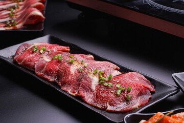 Raw beef slice for barbecue japanese style, yakiniku, meat are being cooked on stove.