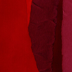 Red vintage and old looking crumpled paper background. Retro cardboard texture. Grunge paper for drawing. Ancient book page. Present wrapping.