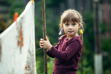 Lovely little girl with clothespin, outdoor