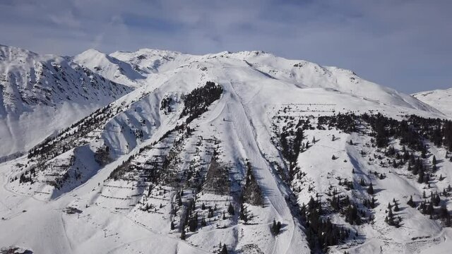 Aerial view of skiers on ski slopes in Horberg area, Mayrhofen ski, Tyrol, Austria. Speeded up from 24 fps.