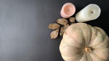 Thanksgiving / Autumn holiday background, top view and copy space. Composition with pumpkin, leaves and candles 