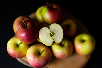 Fresh harvest of red apples on a black background, farm organic fruits