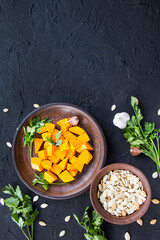 Beautifully chopped pumpkin salad, herbs, and ingredients for the dish. Creative atmospheric decoration