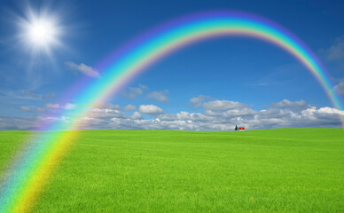 草原の赤い屋根の家と雲と虹と太陽