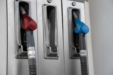 Pistols with gasoline at the gas station. The pistol is missing in the middle. Close-up.