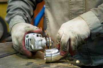 Fitting a polished stainless steel elbow with a sander