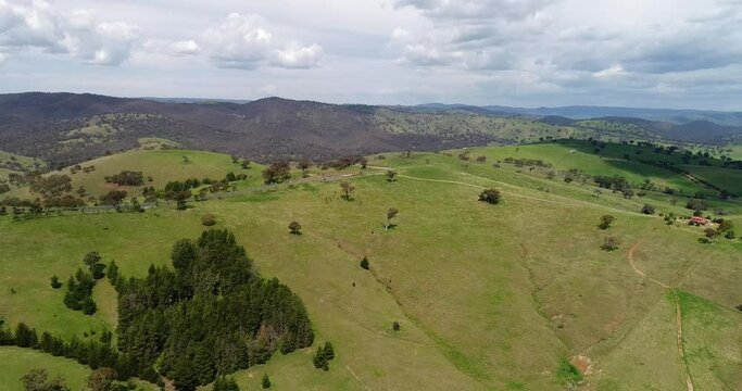 Sofala valley with green pastures of agriculture farms on hill ranges in 4k.
