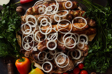 Obraz na płótnie Canvas Assorted different types of grilled meat: pork steak, lula kebab beef and turkey. Barbecue with onions, herbs and vegetables