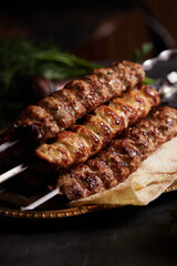 Assorted different types of kebabs: beef, pork, chicken. National Caucasian dish. Close up on dark background