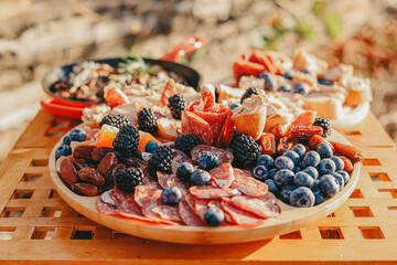 Close-up of the dish with appetizers on a wooden table. Picnic.