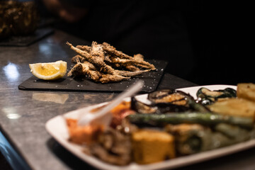 Mediterranean fried anchovies in a black dish
