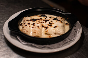Cannelloni with melted cheese over it