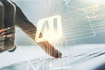 Double exposure of creative artificial Intelligence icon with hands typing on laptop on background....