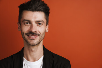 Photo of joyful handsome man smiling and looking at camera