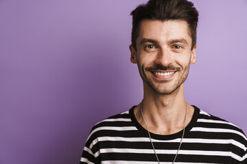 Photo of joyful handsome man smiling and looking at camera