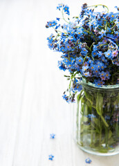 Bouquet of forget-me-not flowers in glass vase