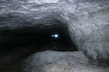 old abandoned galleries, adits, for extraction and processing of natural stone and gypsum cave. Dark eerie stone, quartz tunnels deep in  earth. Various rocks, geological and speleological research.