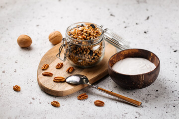 Breakfast yogurt in wooden bowl with granola