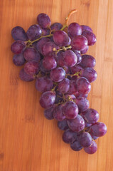 bunch of green grapes on the wooden