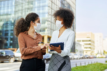 Two business afro people with face masks in the city