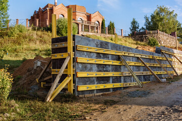 The construction of a retaining wall or counterfort, formwork, reinforced, preparation to pour...