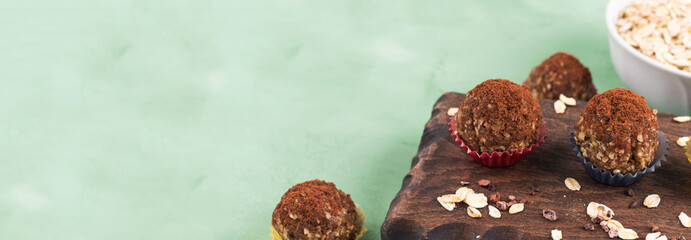 Protein energy balls with cocoa, dried fruit, nut butter and seeds. Healthy dessert, snack.