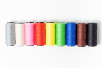 Threads of light dark colors on white background, top view