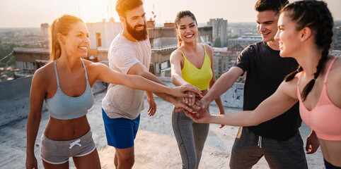 Group of happy friends or sportsmen exercising outdoor