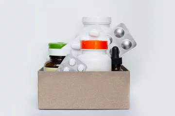 Image of a box of compounded prescription medications shipped from a mail order pharmacy on a lihgt background. © Iryna