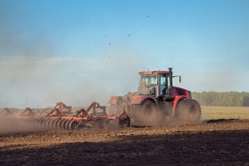 tractor plows the land before sowing winter wheat varieties