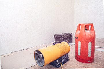 Installation of the stretch ceiling. Repairers stretch the stretch ceiling with a gas heat gun. Space for text