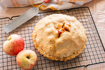 Autumn classic American fair apple pie with crust, on the kitchen table, autumn classic desserts 