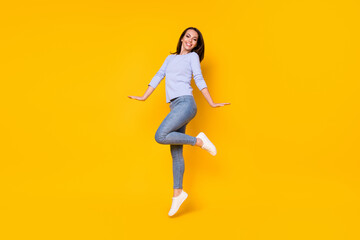 Fototapeta na wymiar Full length body size view of her she nice attractive pretty cheerful cheery girl jumping having fun enjoying good mood cozy comfort wear isolated bright vivid shine vibrant yellow color background